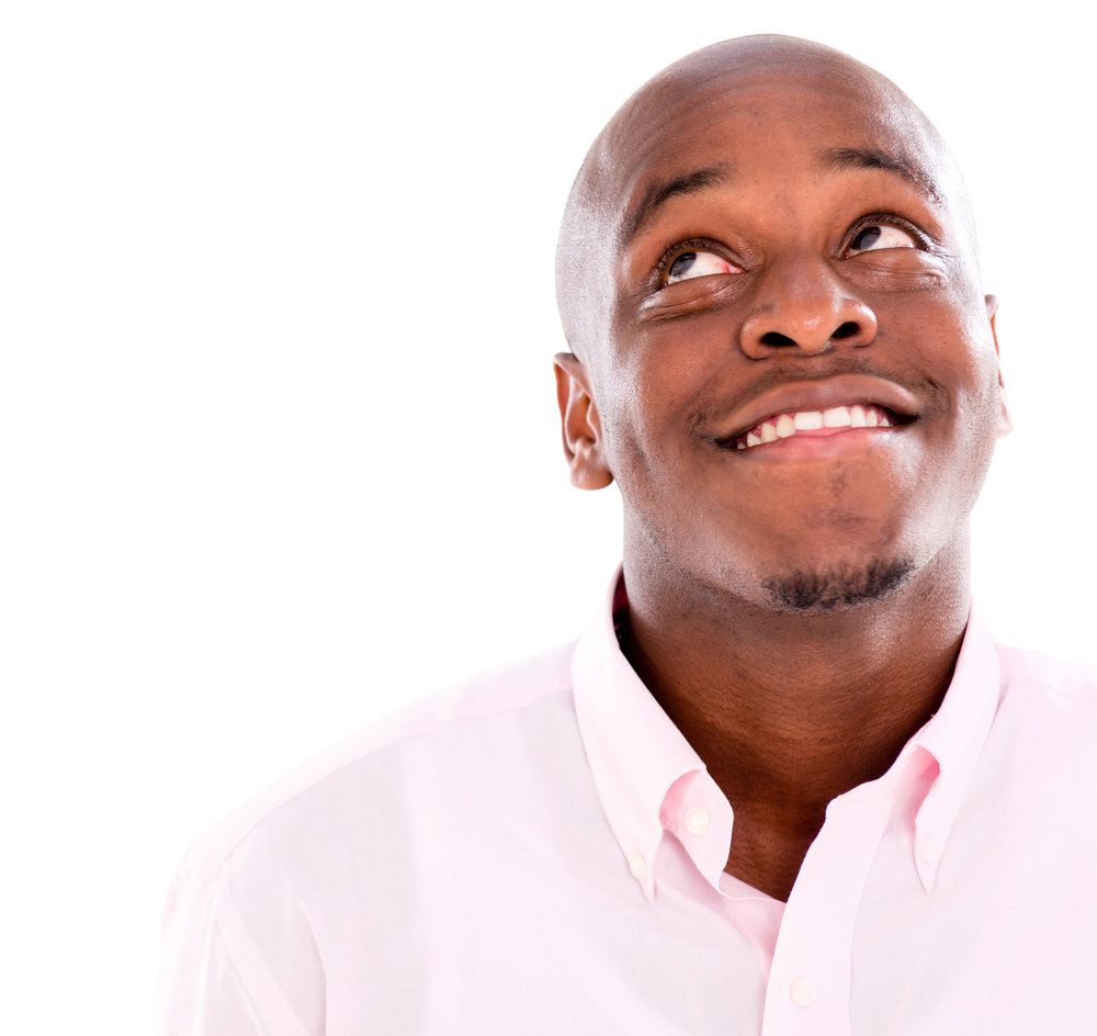 Pensive business man looking up - isolated over white background.